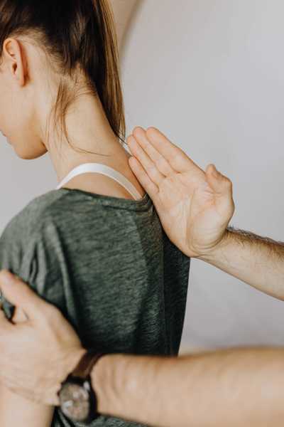 Woman getting her posture assessed by a chiropractor